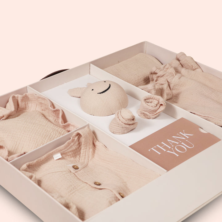 La Plume 7-Piece Muslin Newborn Gift Set | Swaddle, Romper, Bib, Washcloths, Pillow &amp; Soft Toy