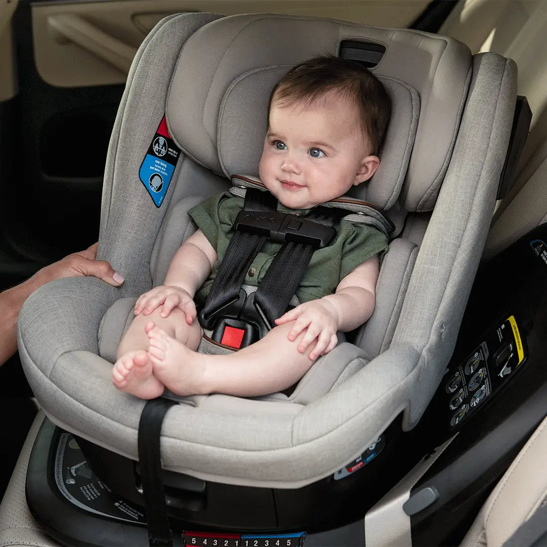 Nuna revv™ car seat showing its rotation towards the vehicle door