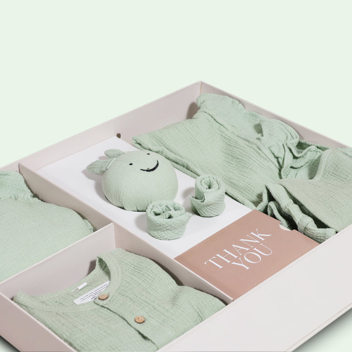 La Plume 7-Piece Muslin Newborn Gift Set | Swaddle, Romper, Bib, Washcloths, Pillow &amp; Soft Toy
