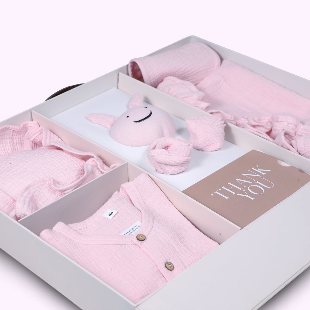 La Plume 7-Piece Muslin Newborn Gift Set | Swaddle, Romper, Bib, Washcloths, Pillow &amp; Soft Toy