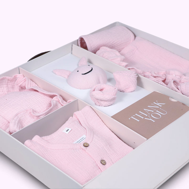 La Plume 7-Piece Muslin Newborn Gift Set | Swaddle, Romper, Bib, Washcloths, Pillow &amp; Soft Toy