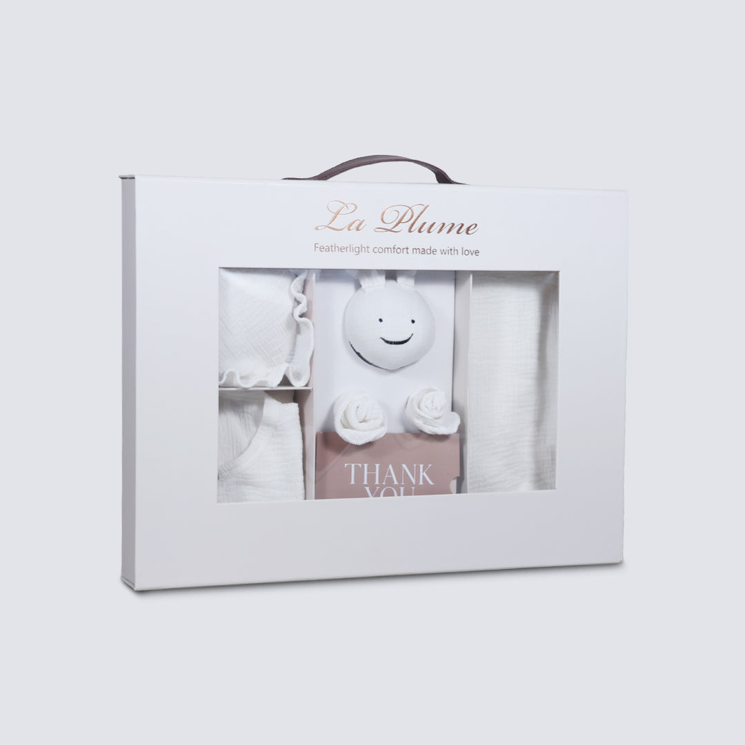 La Plume 7-Piece Muslin Newborn Gift Set | Swaddle, Romper, Bib, Washcloths, Pillow &amp; Soft Toy