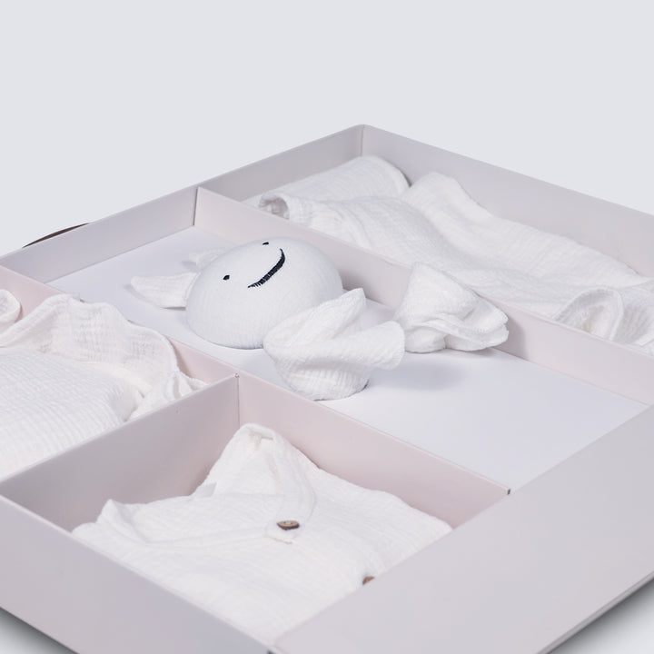 La Plume 7-Piece Muslin Newborn Gift Set | Swaddle, Romper, Bib, Washcloths, Pillow &amp; Soft Toy